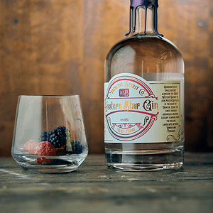Western Star Wild Berry gin with glass including fresh berries